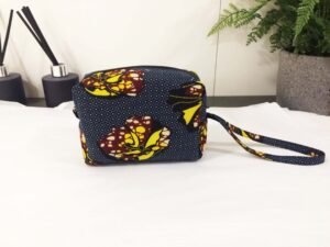 Box purse with wrist strap.