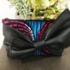 Fabric clutch bag, pink, blue, black background with PU bow