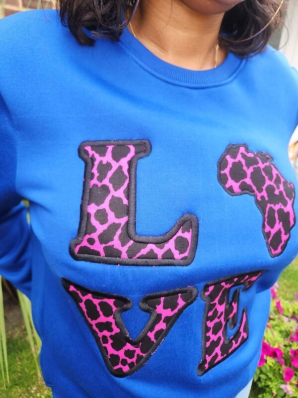030e1144-7fd0-4aa4-90b1-f97c2dd6e042 Ankara “LOVE Africa” Sweatshirt – Royal Blue | Leopard Print Appliqué
